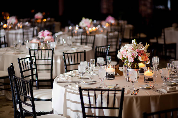 Multiple tables with centerpieces at an indoor elegant wedding reception